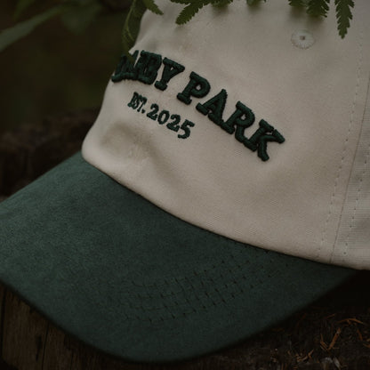 Close-up of the embroidered Darby Park, Est. 2025 wordmark and green faux suede brim on the Canvas Cap.