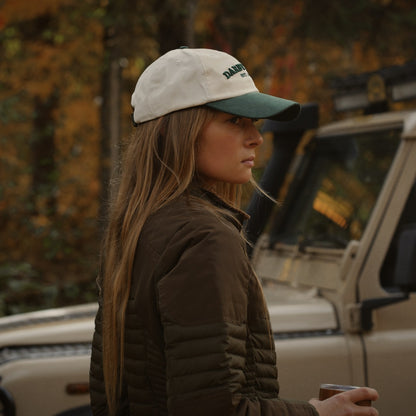Side view of the Canvas Cap worn with long hair beside a vintage truck.