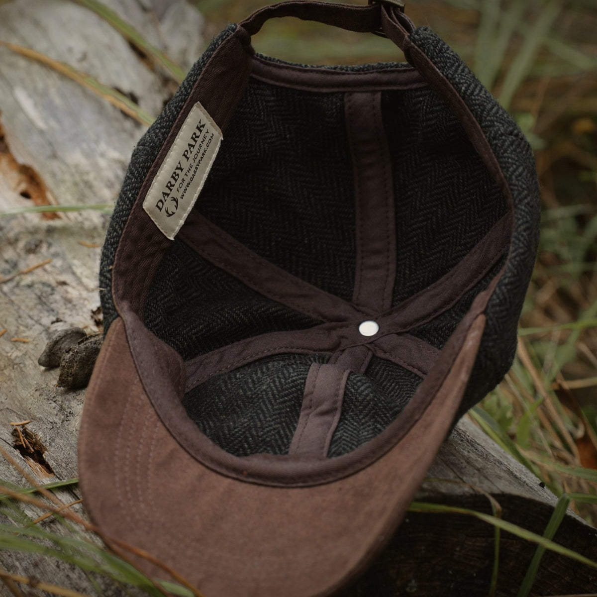 Underside of the Tweed Cap, showing the brown faux suede brim and cotton-lined crown.