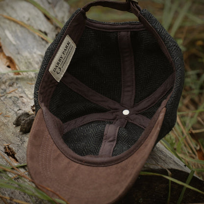 Underside of the Tweed Cap, showing the brown faux suede brim and cotton-lined crown.